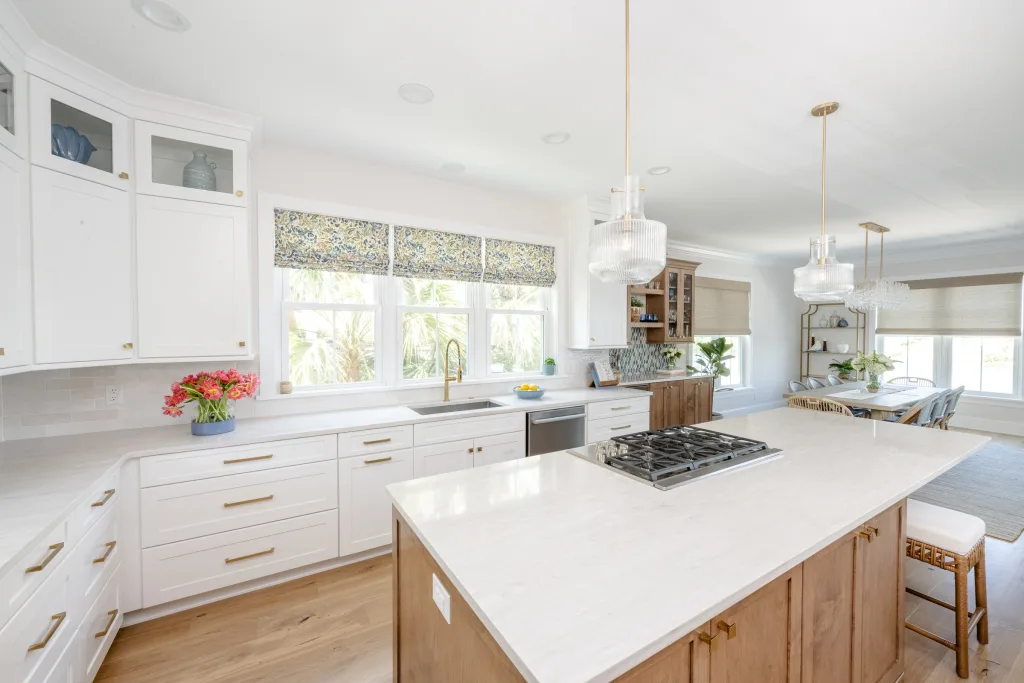 Light-filled kitchen and dining vignette with patterned window blinds in Charleston, SC