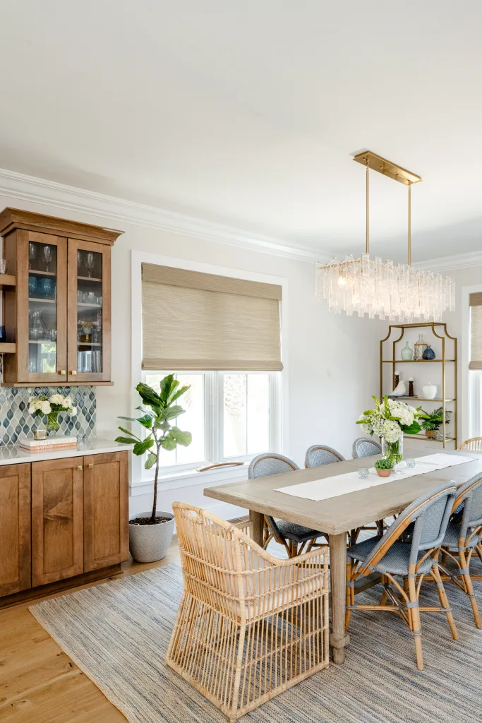 Dining area with wood table, rattan and upholstered chairs in Charleston, SC